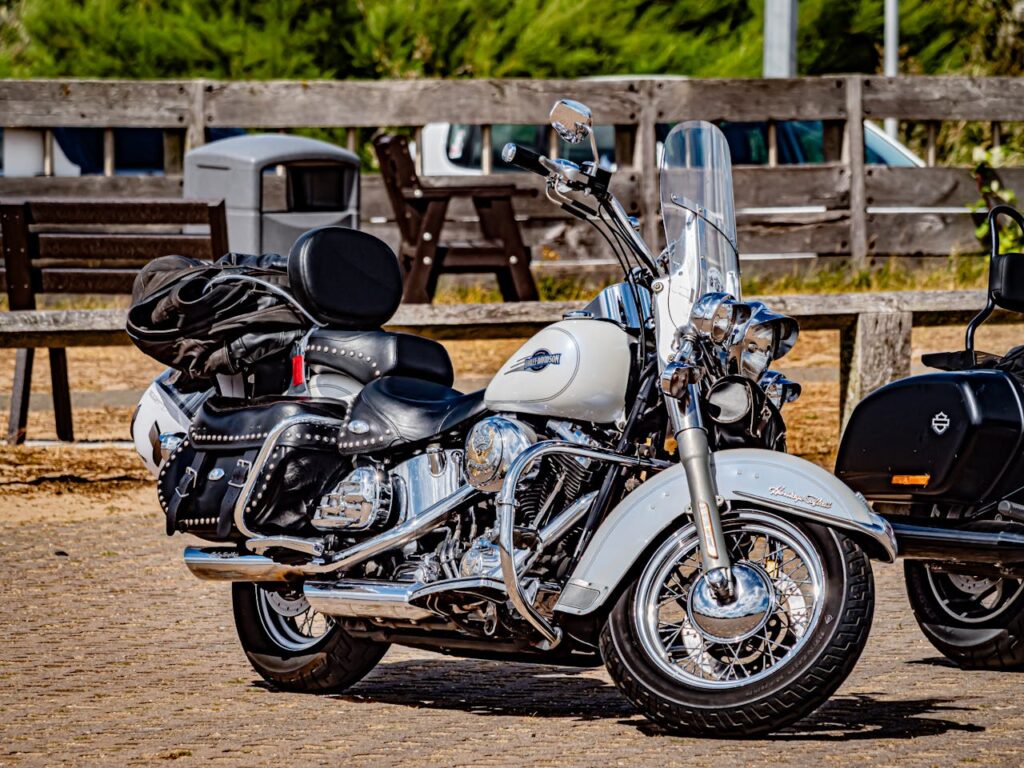 Vintage Harley Davidson motorcycle parked outdoors in warm sunlight.